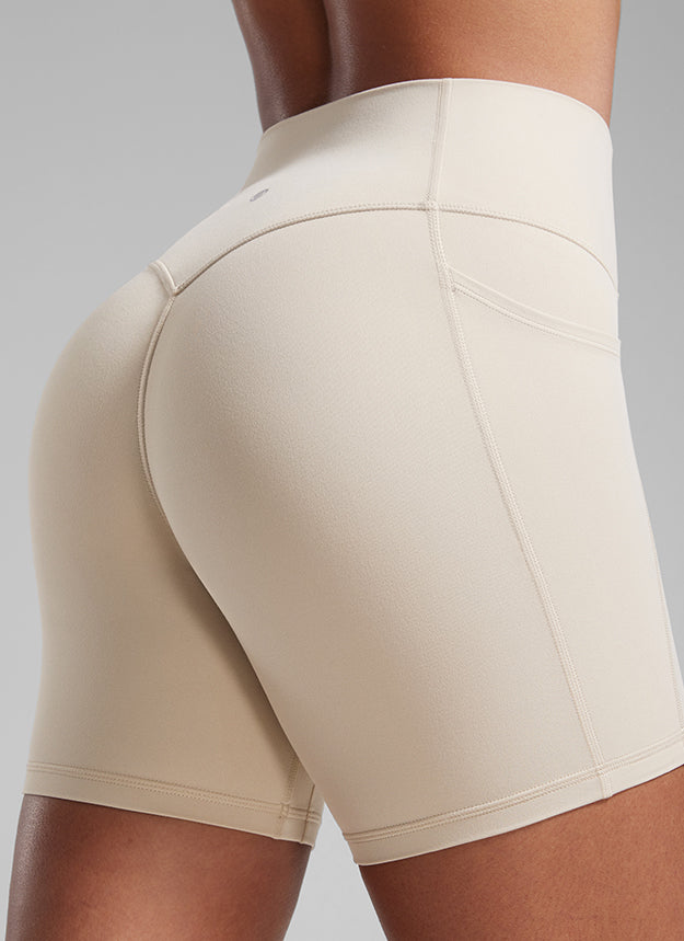 CRZ YOGA Butterlift Womens Scrunch Butt No Front Seam Pocket Biker Shorts 5'' Mojave Tan @model_info:Crystal